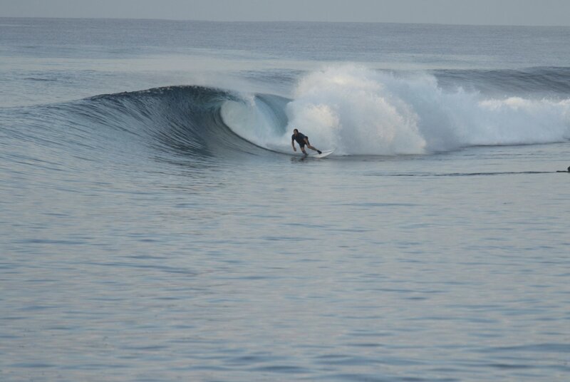 Riding a reef break wave in the Mentawai Islands